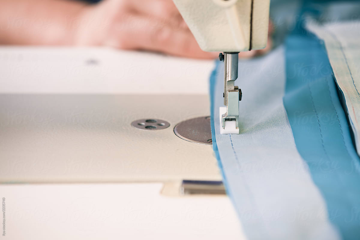 Woman working sewing machine sew cloth fabric