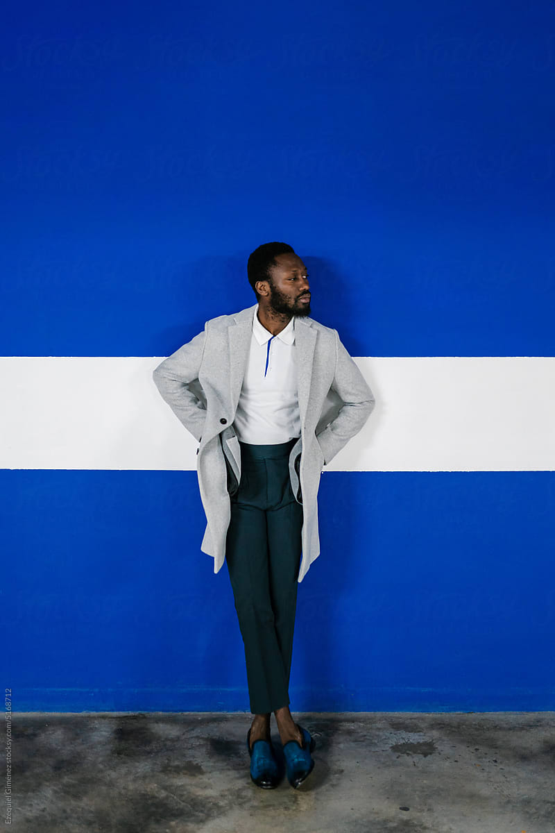 Stylish African American man leaning on wall