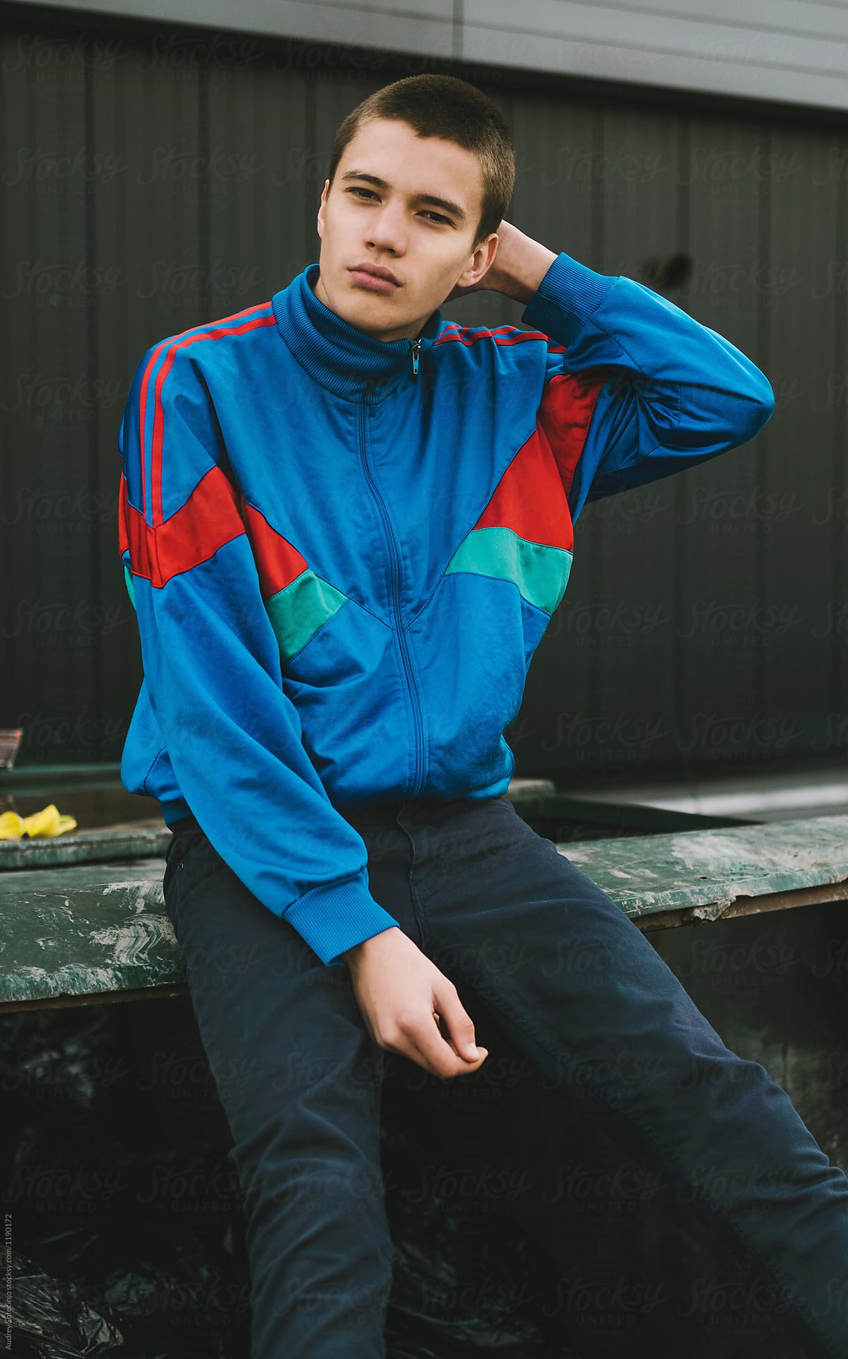 Young adolescents in colorful  track suits from 90's in east Europe projects.