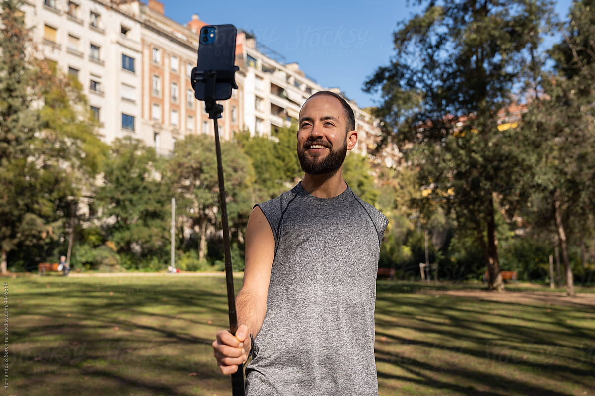 Man With Disability Using Phone On Selfie Stick