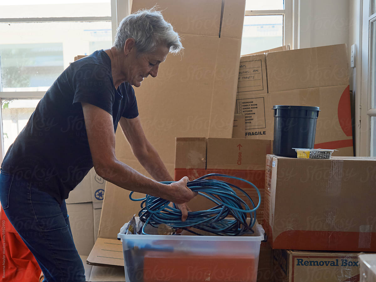 Older woman packing up tools during house move