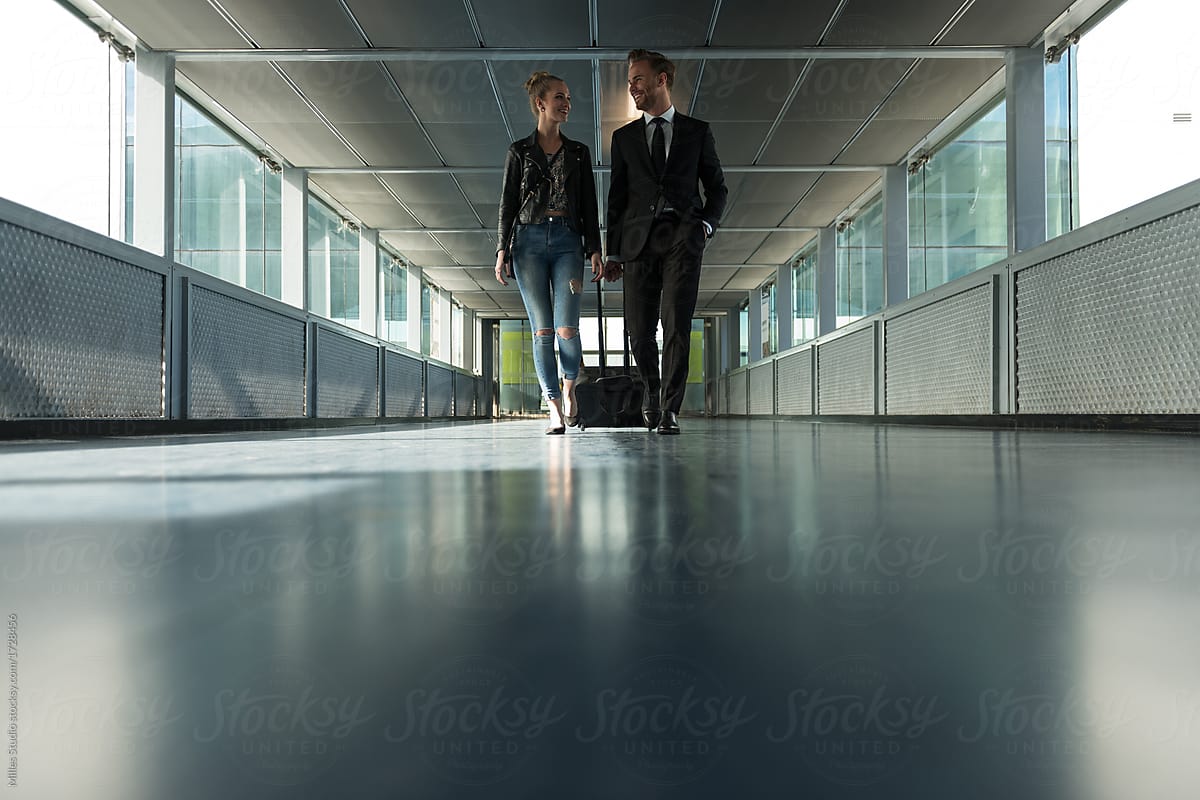 Young stylish people walking in airport passage