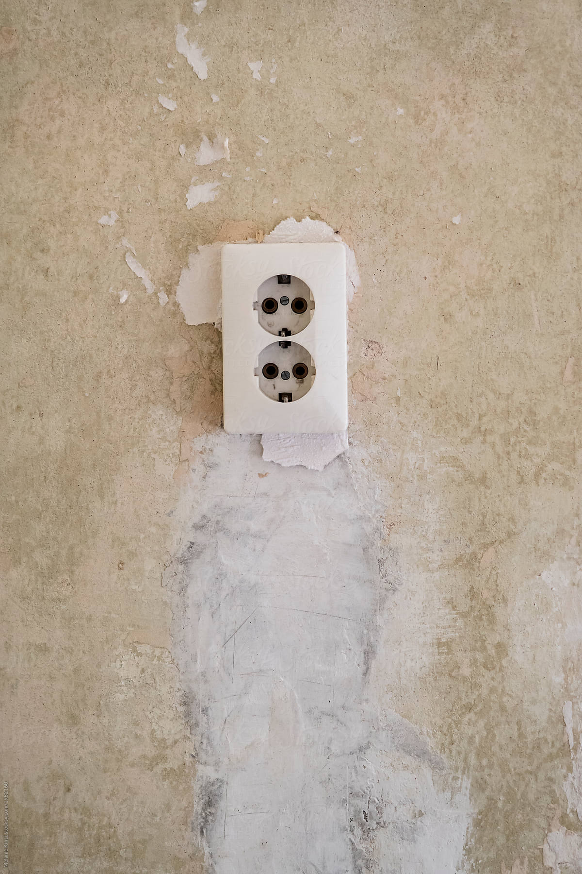 Old-fashioned outlet on a bare wall