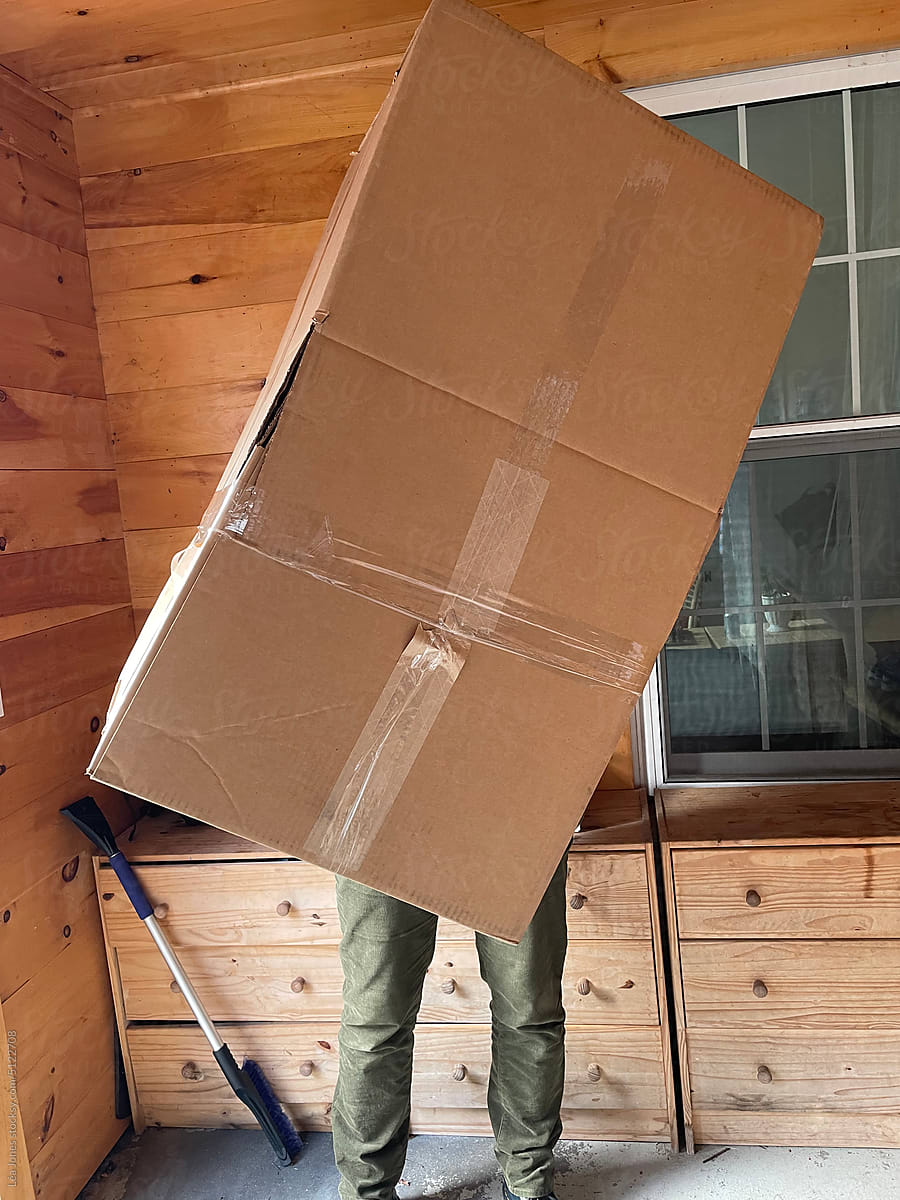 UGC of anonymous  woman carrying a big box