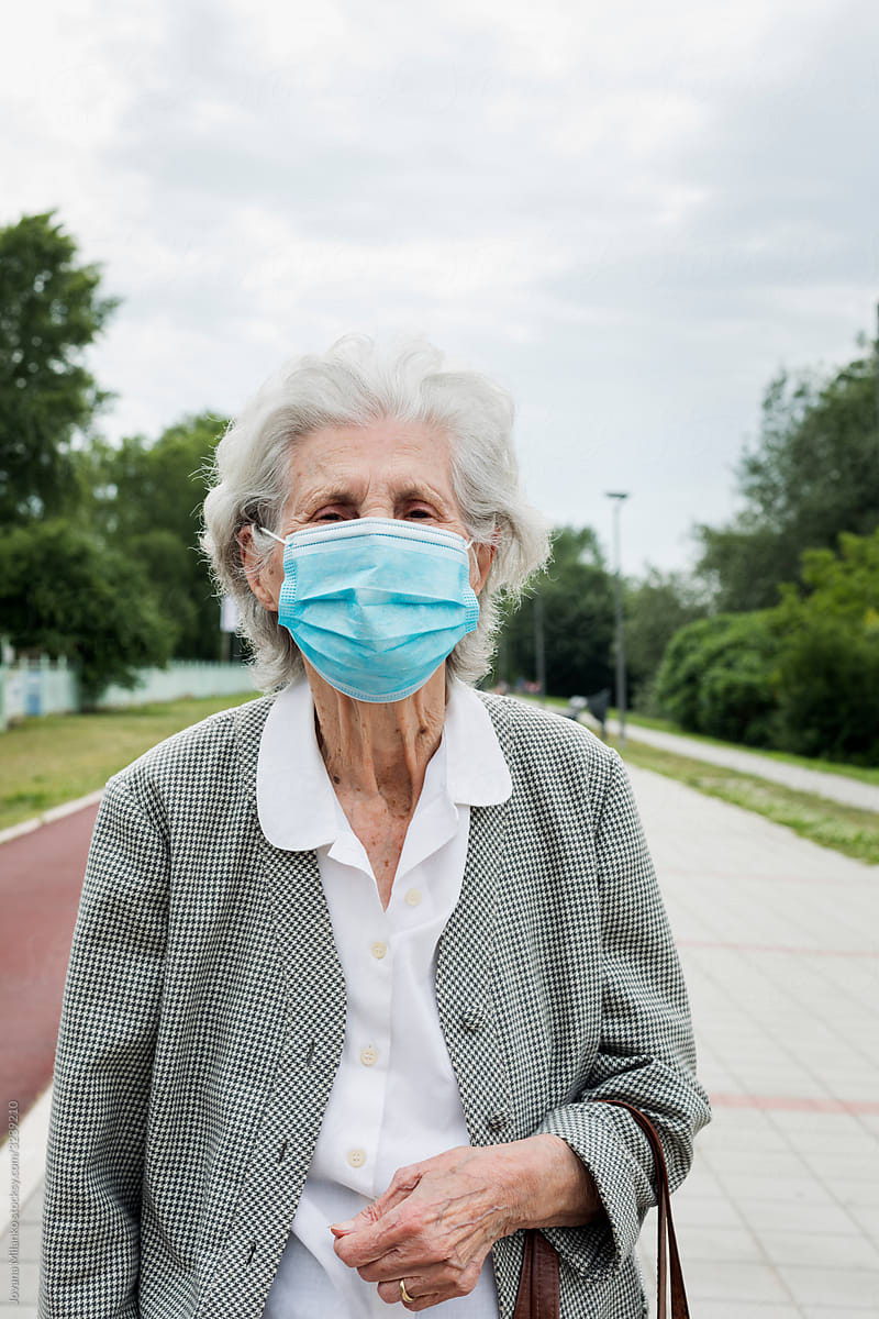 Senior woman outside wearing a medical mask