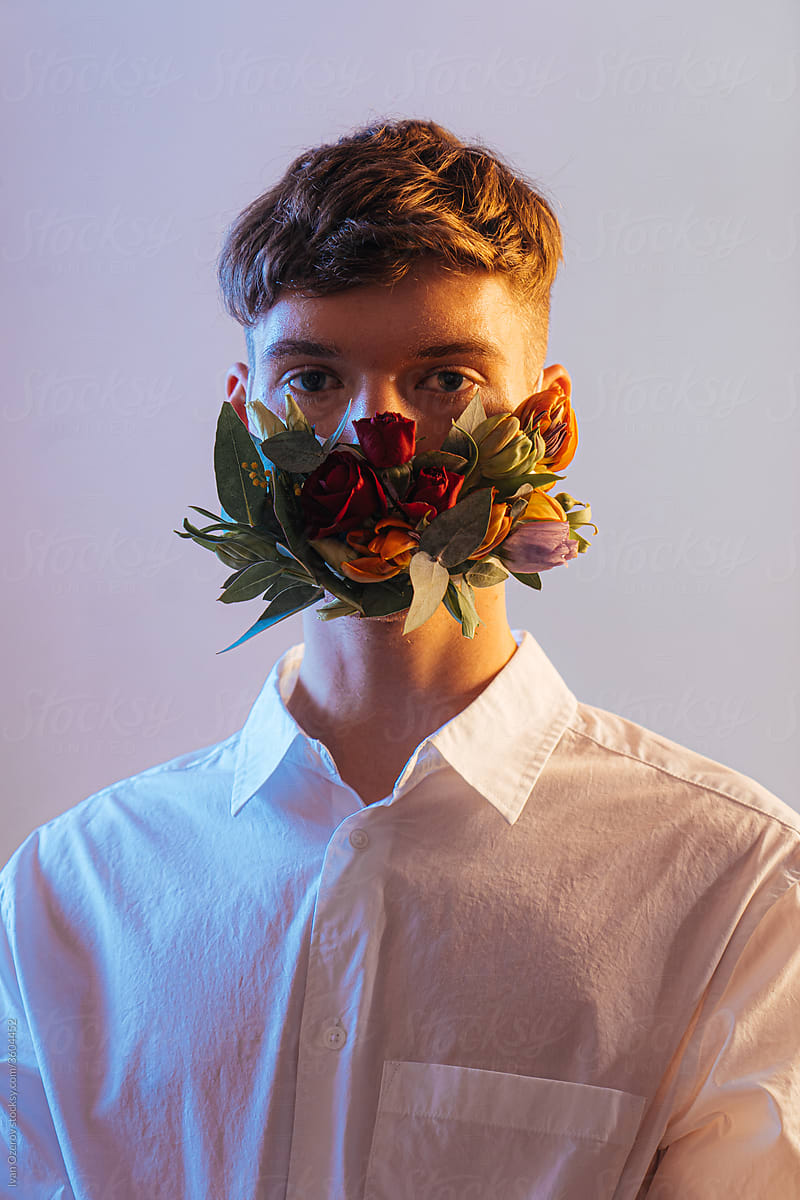 studio shot of a man wearing a flower mask