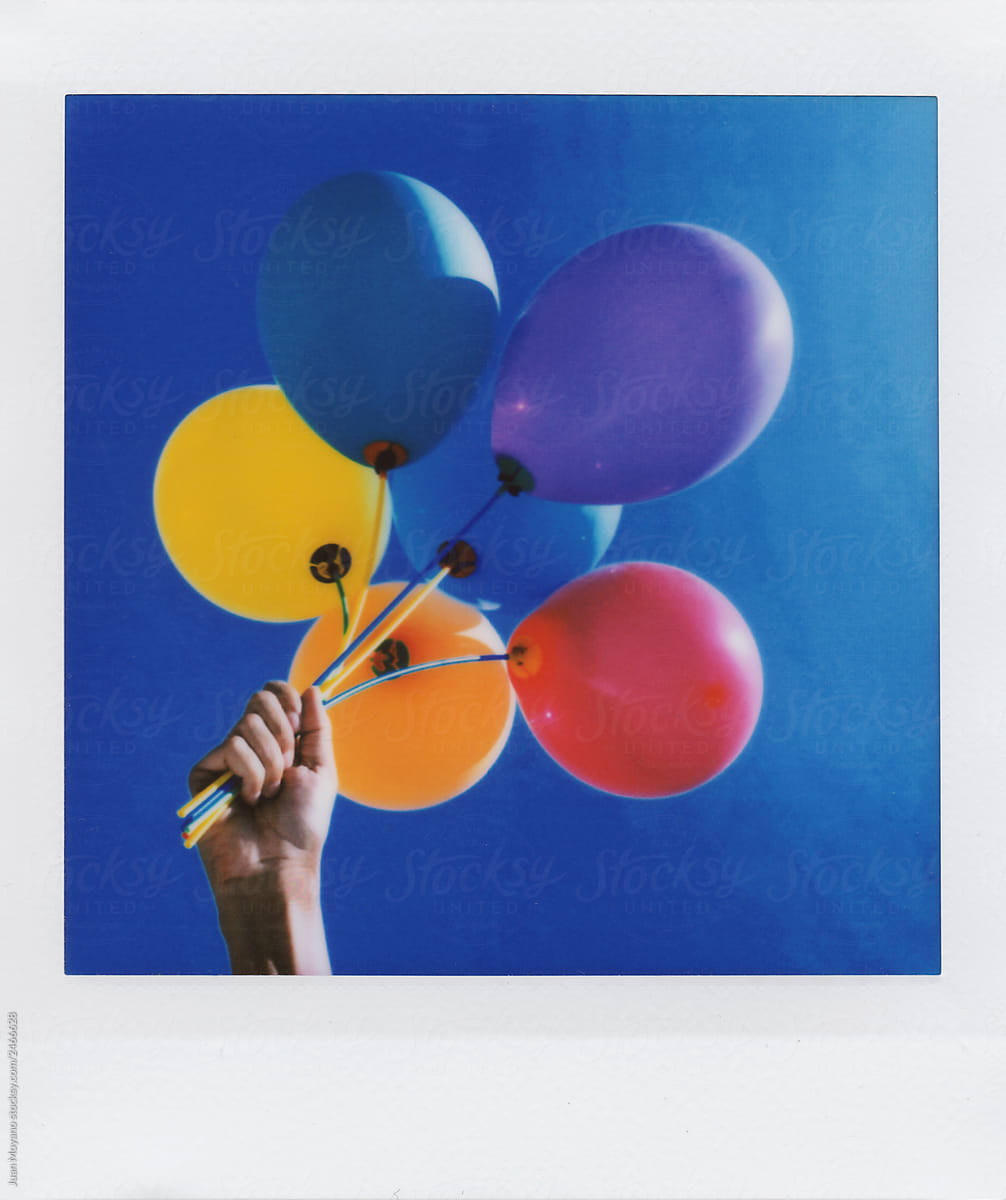 man with a bunch of balloons