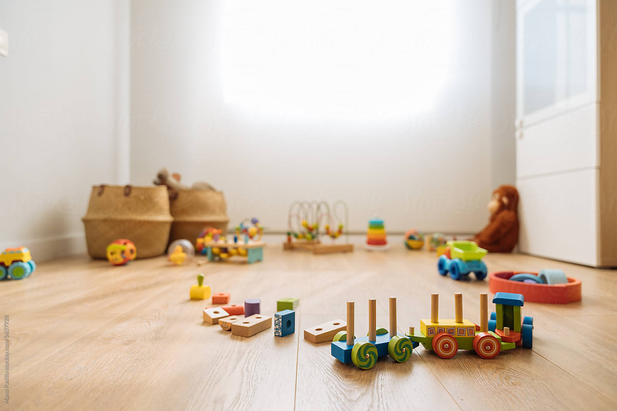 Various children toys on laminated floor in daylight