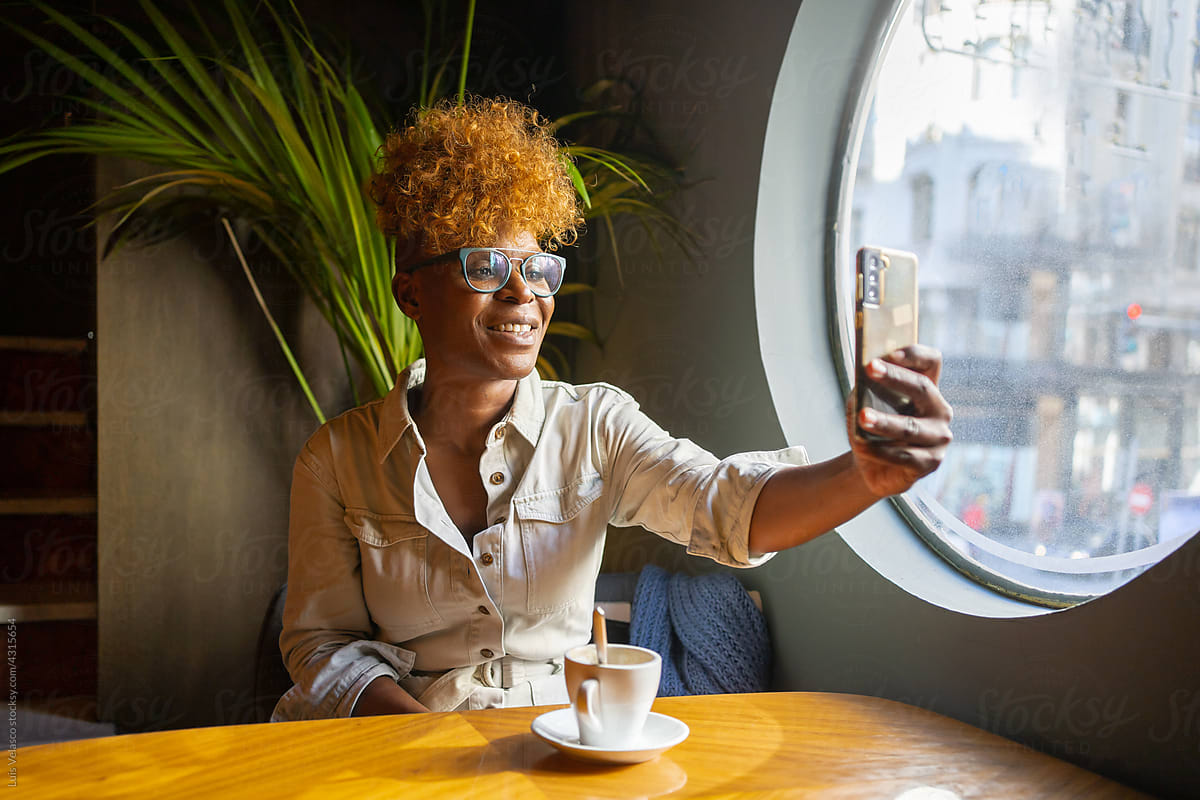 Black Woman Having A Video Call In A Cafe.