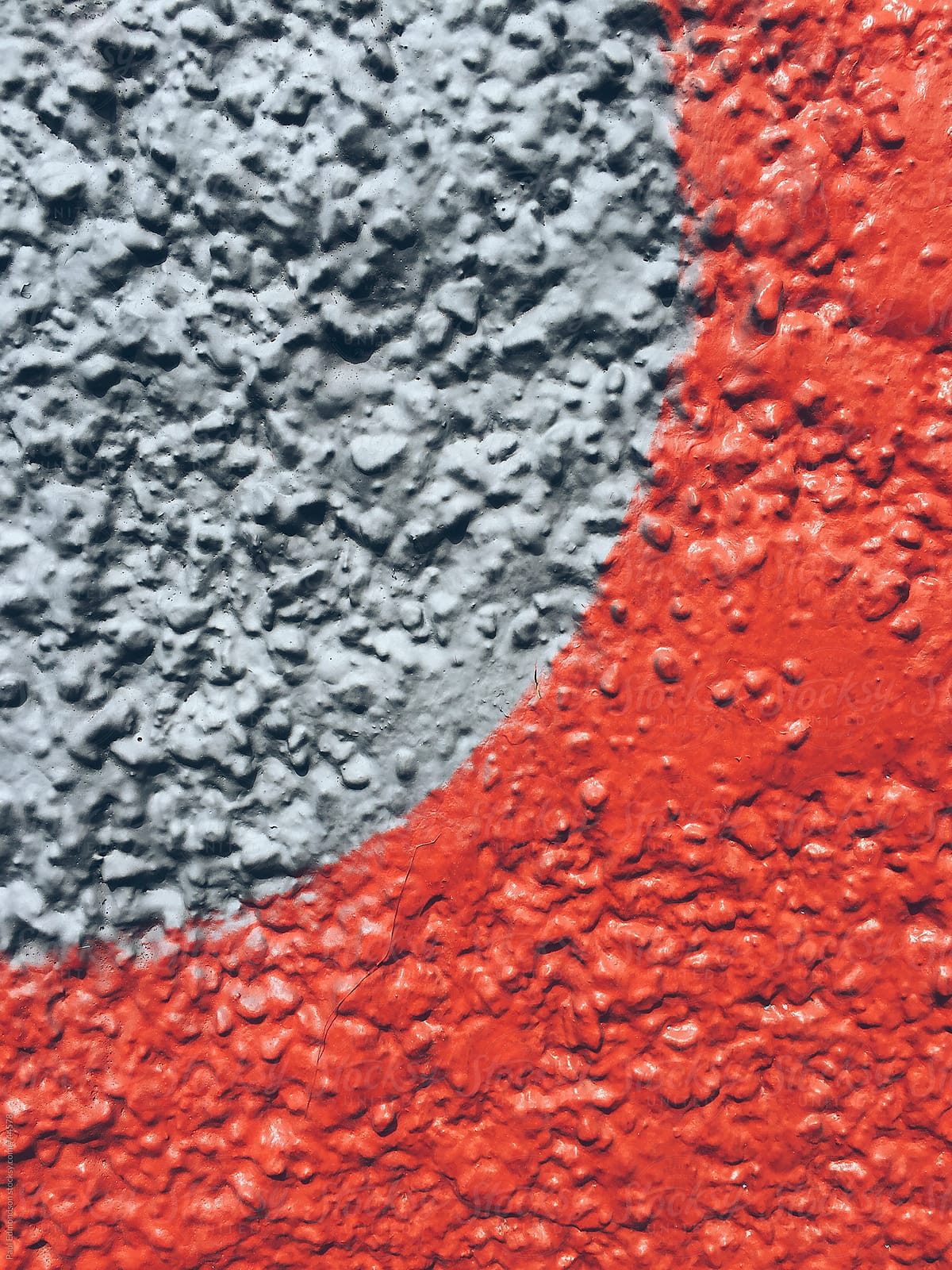 Circular painted shapes on bright red wall, close up