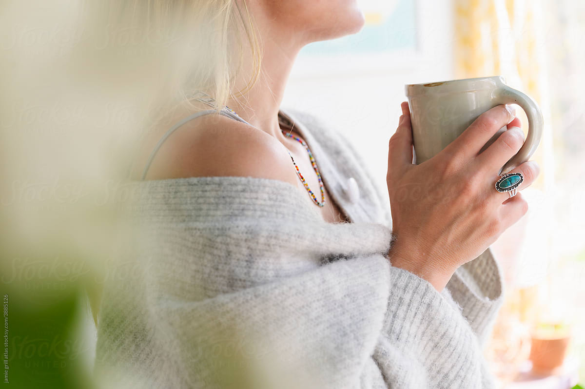 Enjoying a Cozy Mug of Tea in a Sweater at Home