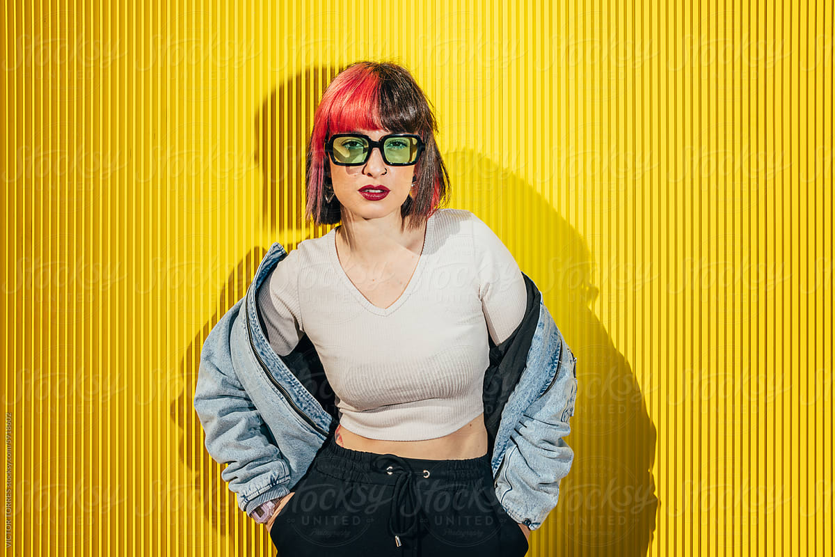 Hip Woman with Red Hair Against Yellow Background