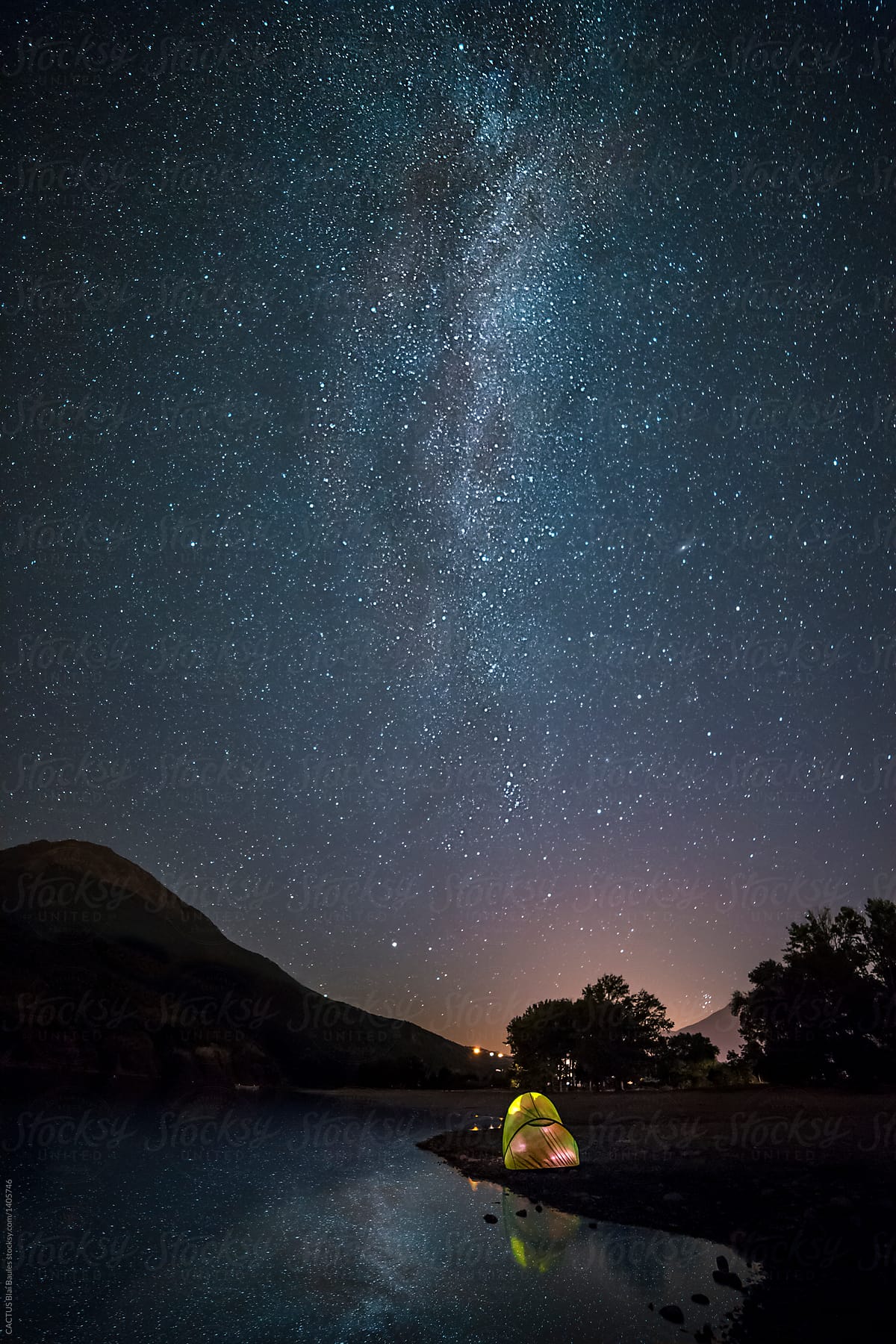 A tent on the lake beach under the milky way