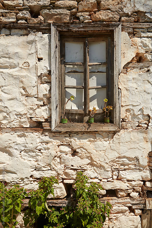 Old wooden window on old stone house