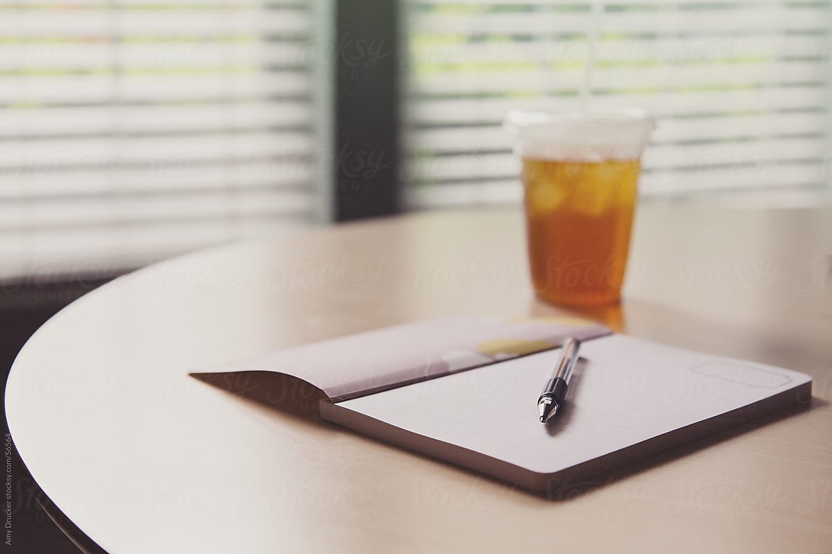 Empty Notebook with Iced Tea on a Table