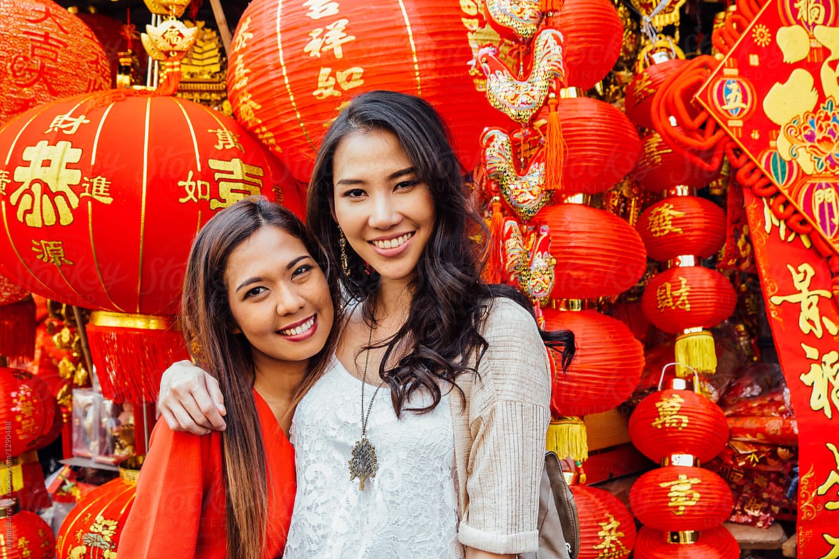 Friends Posing in Front of Many Lanterns
