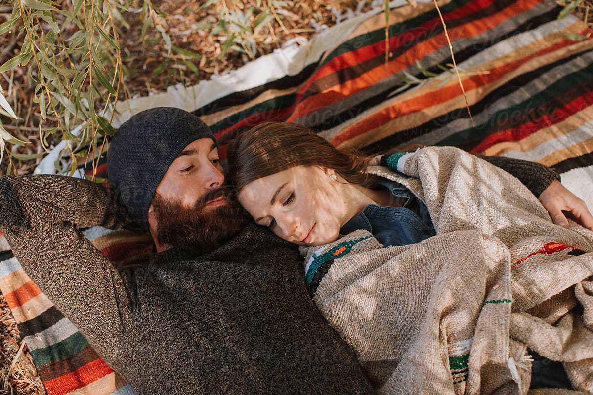 Couple Cuddled On Blanket By Stocksy Contributor Leah Flores Stocksy