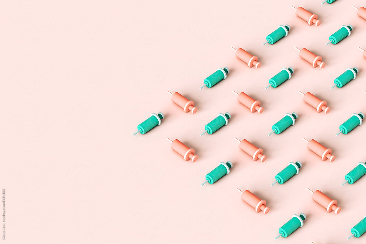 syringes organized on a pink background. copy space