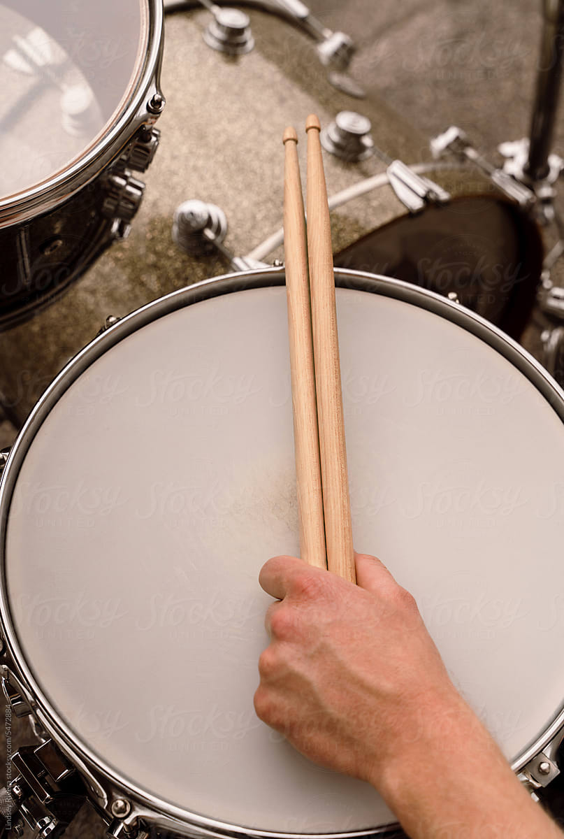 Hand Holding Drumsticks