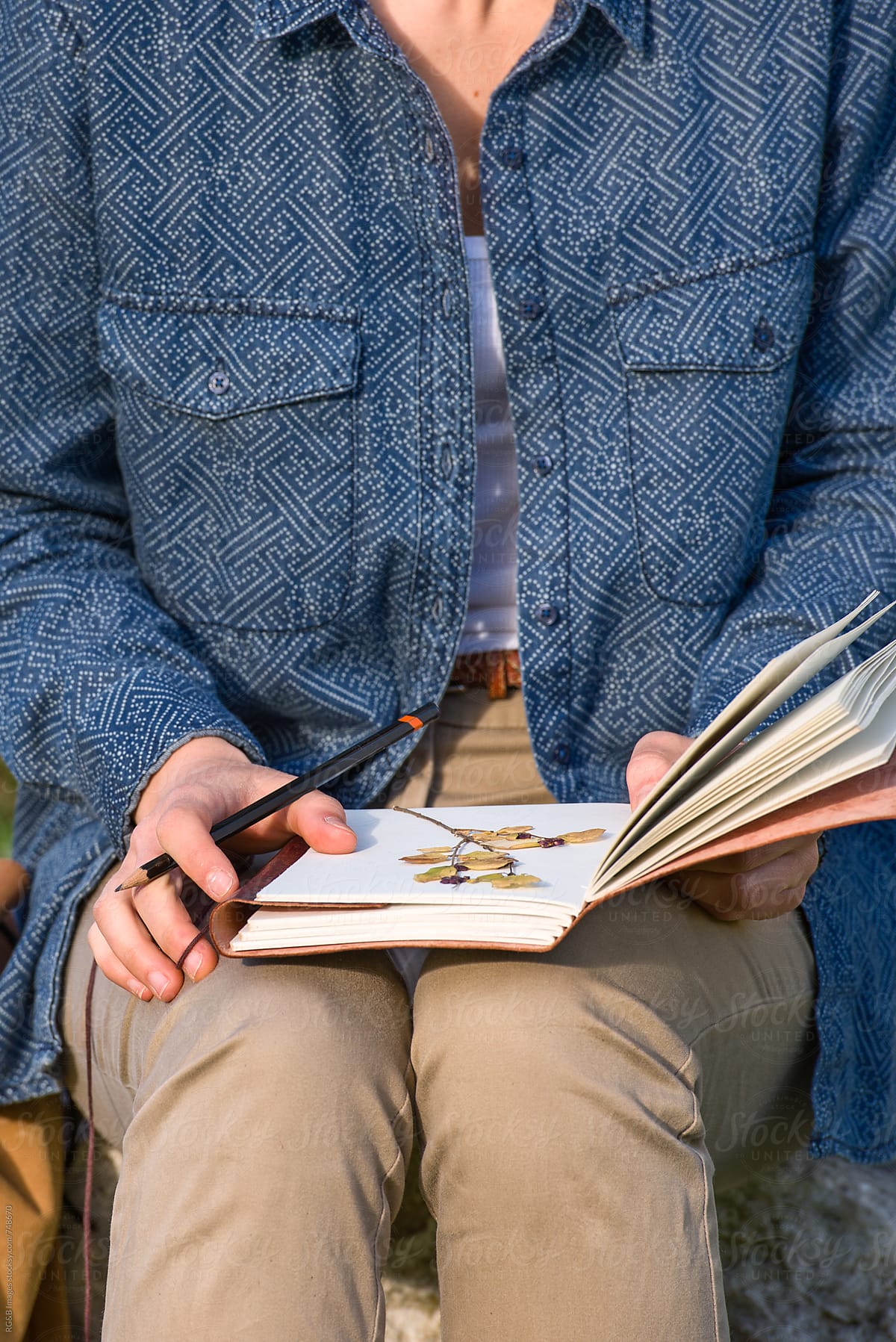 Closeup of a woman writing in a memory book
