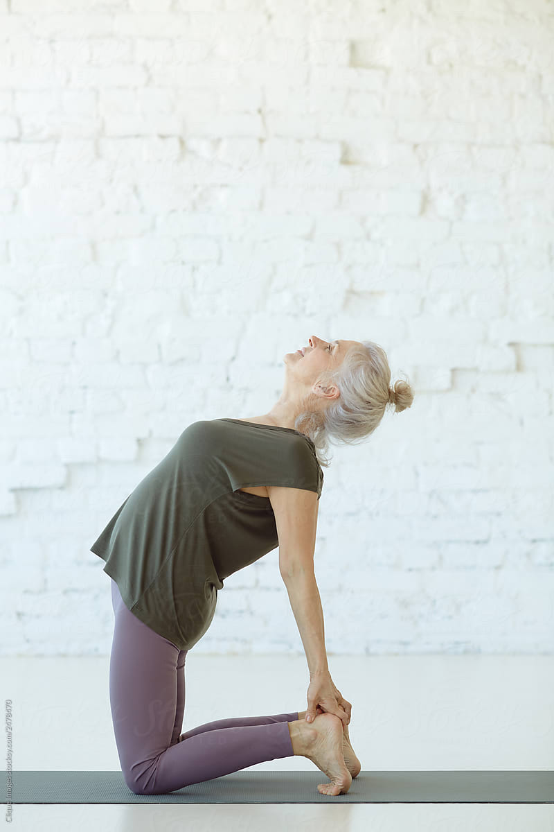 Senior Woman Practicing Yoga Exercise