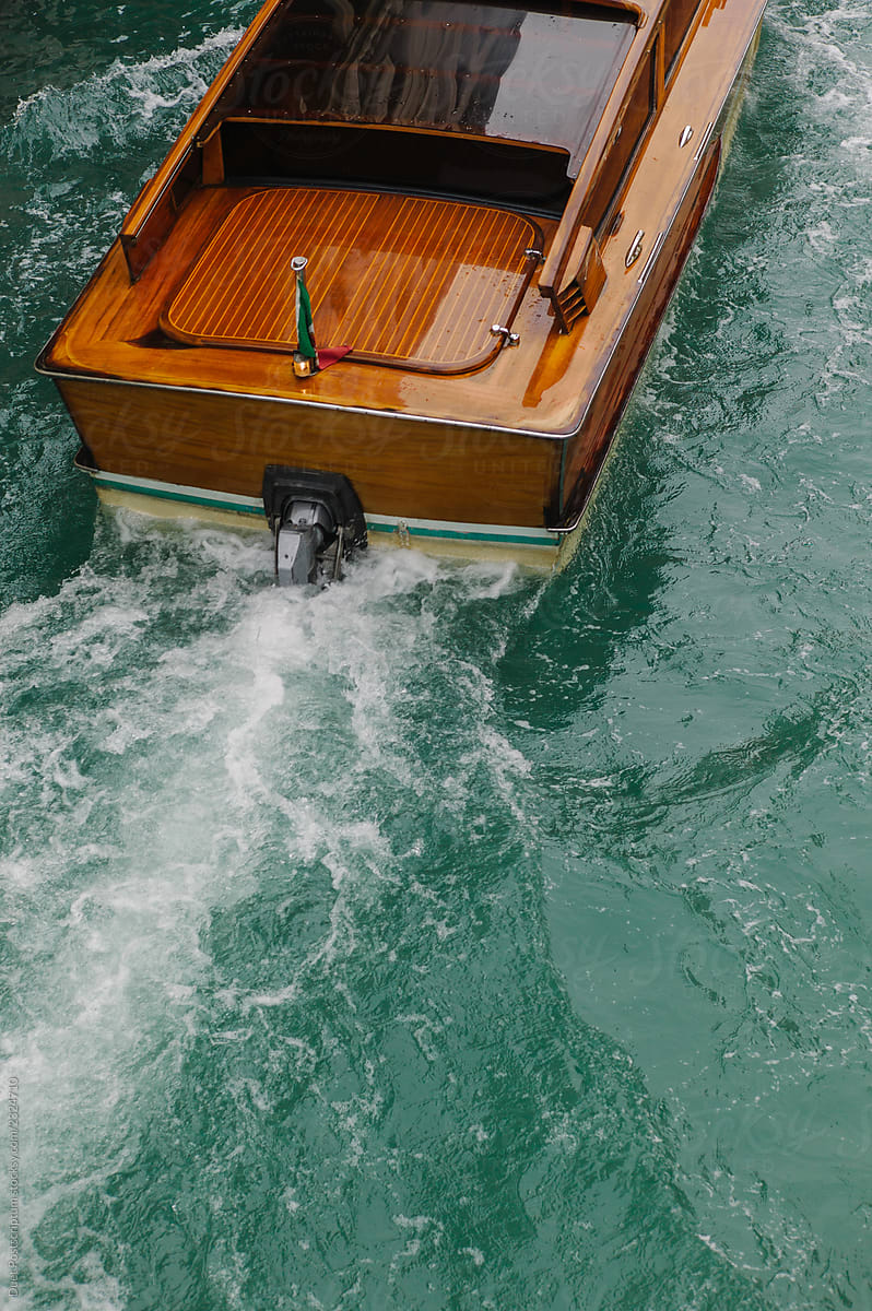 Canal water splashing under motorboat. Water taxi in Venice.