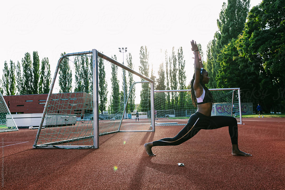 Track and Field - Female African Athlete Stretching