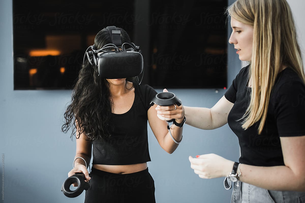 Two girls playing with VR headset