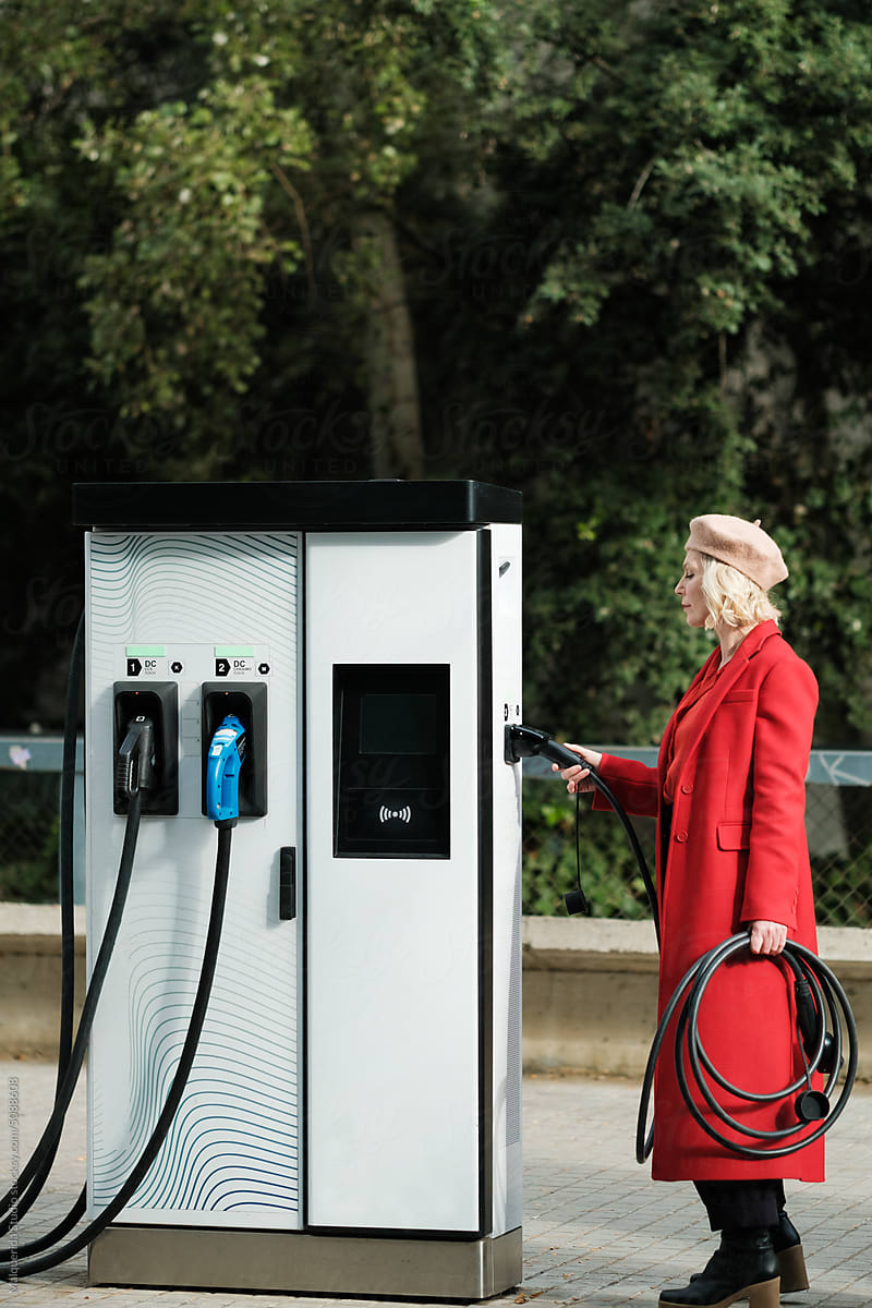 Woman charging electric Car on Charge Station