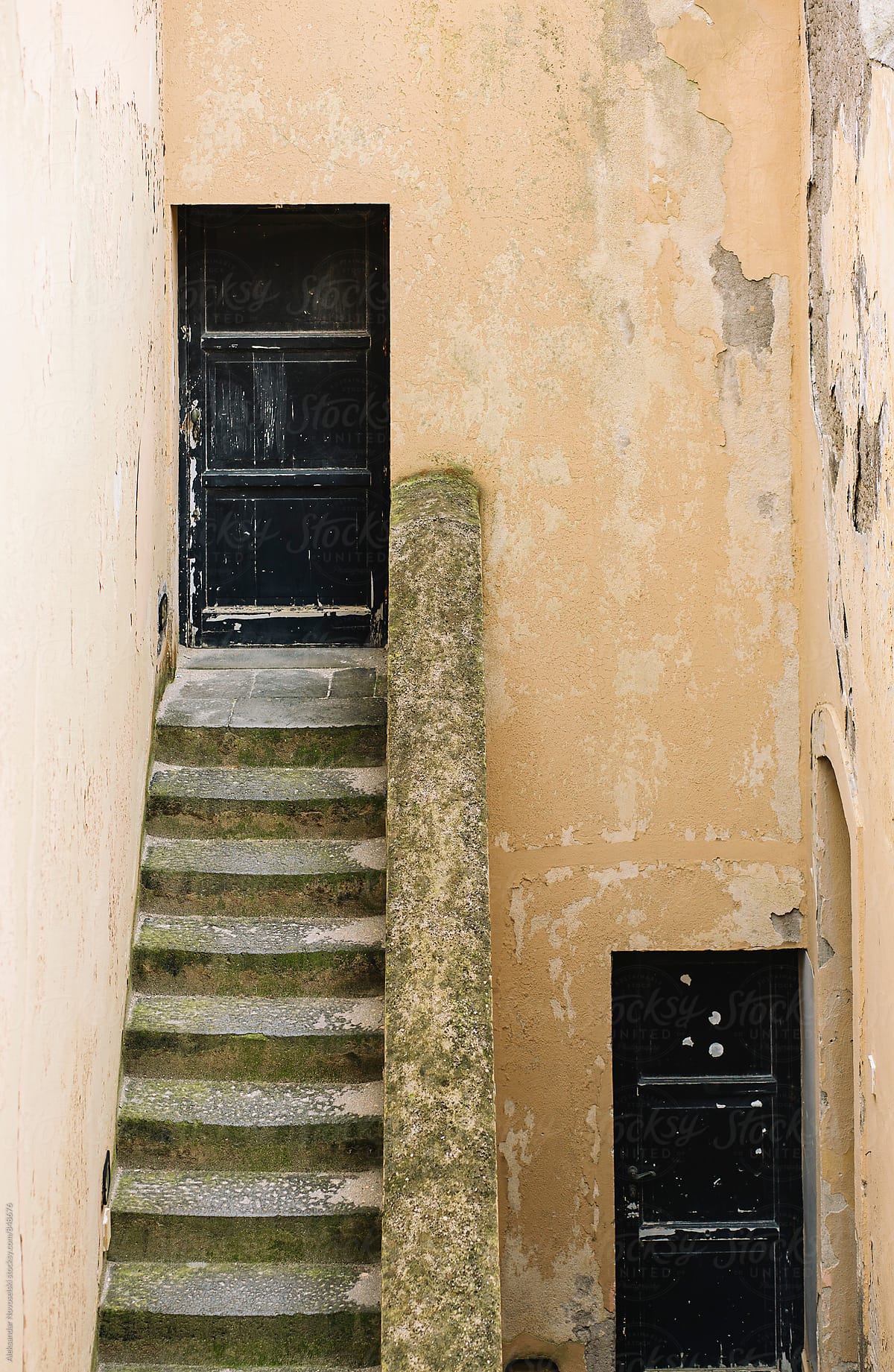 Minimalistic shot of two doors and stairs in Italy