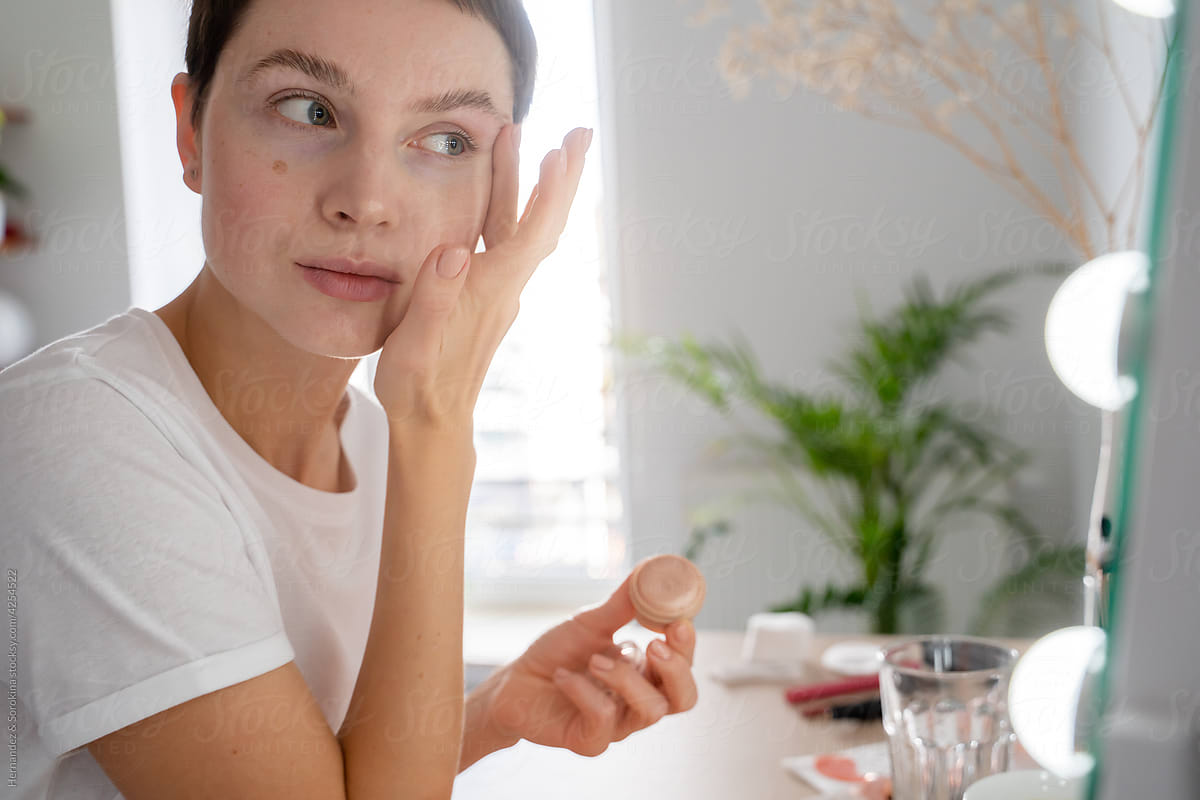 Woman Applying Make-up Product Using Fingers