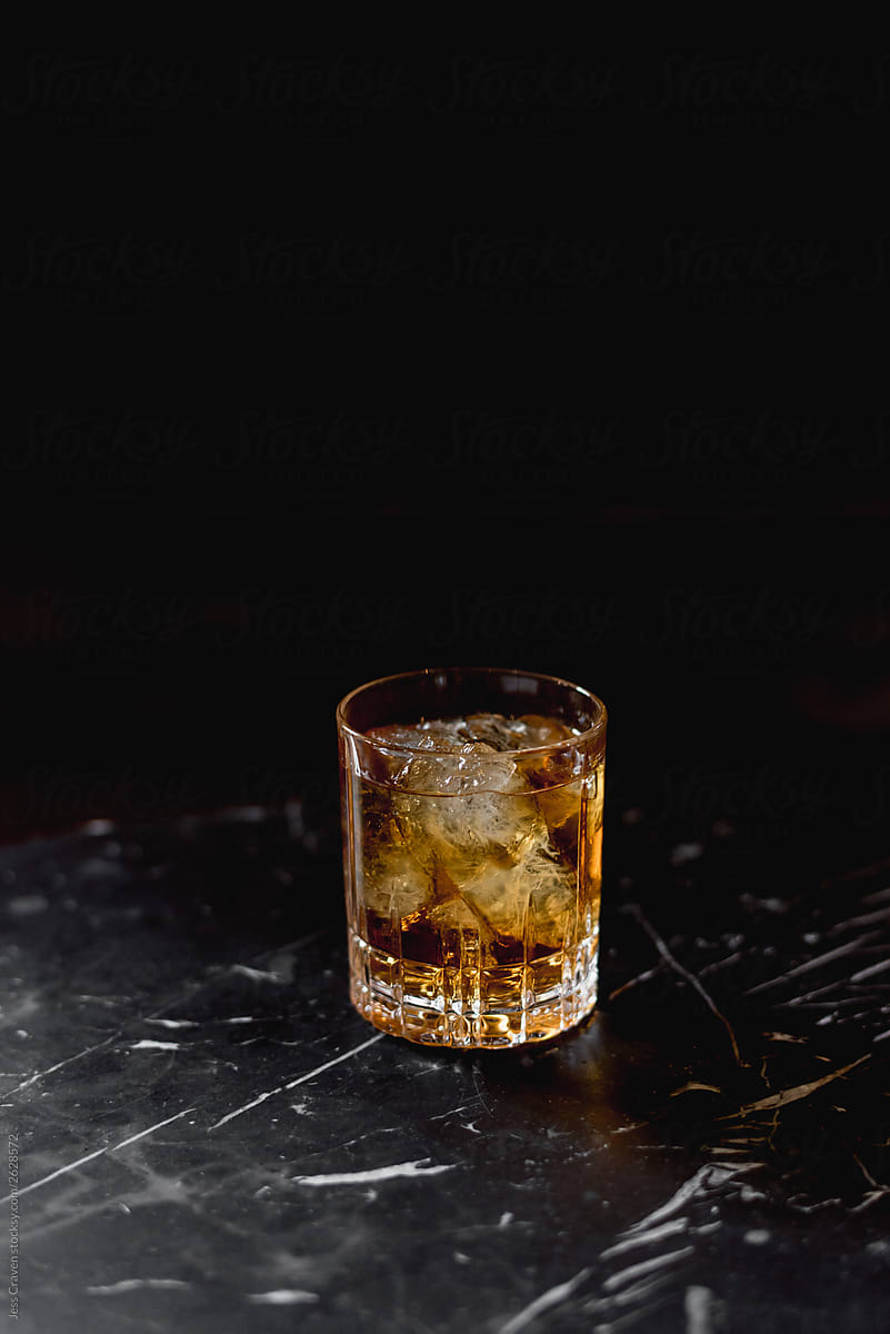 Drink in glass on black marble surface