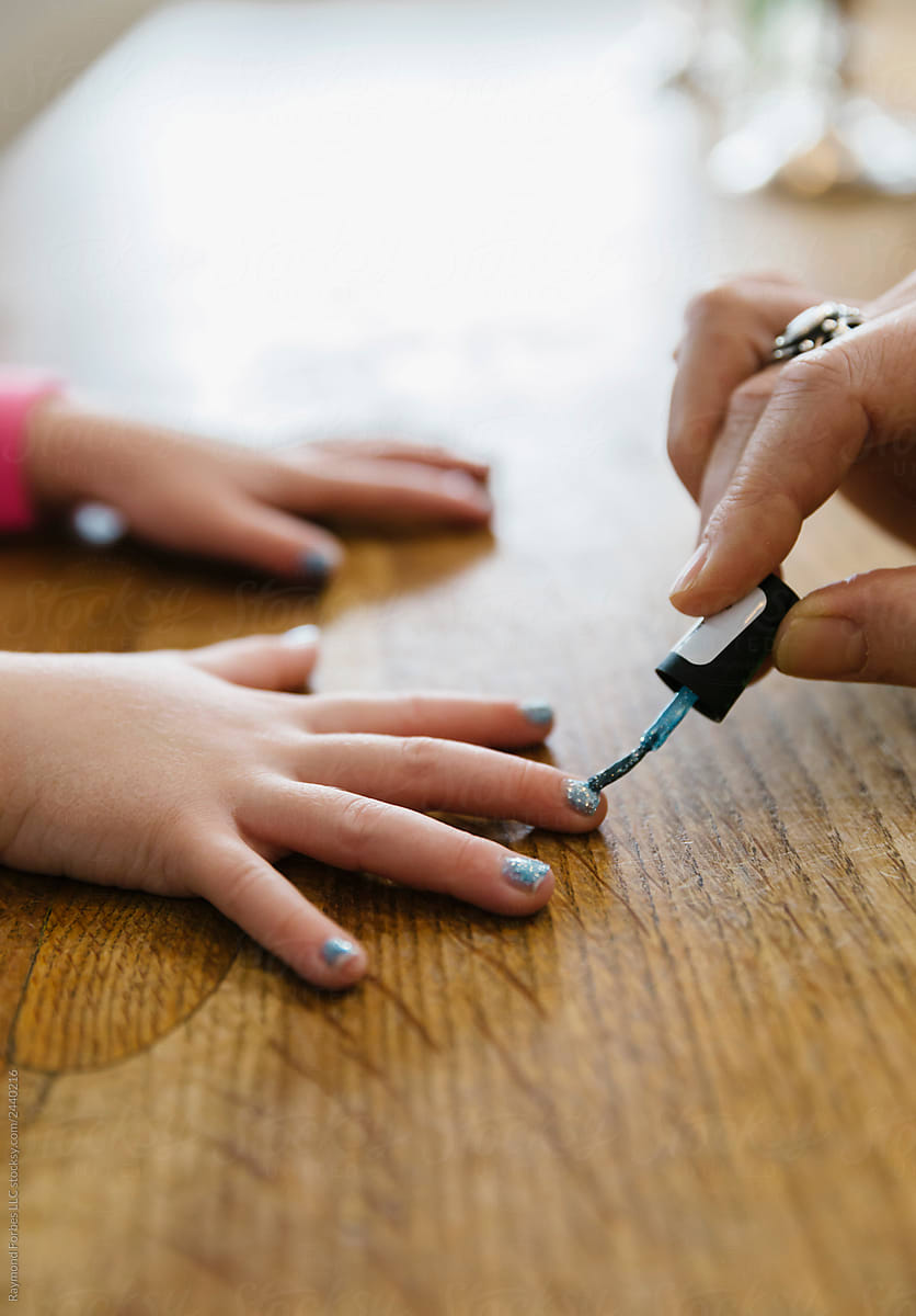 Mother Painting Child\'s Fingernails
