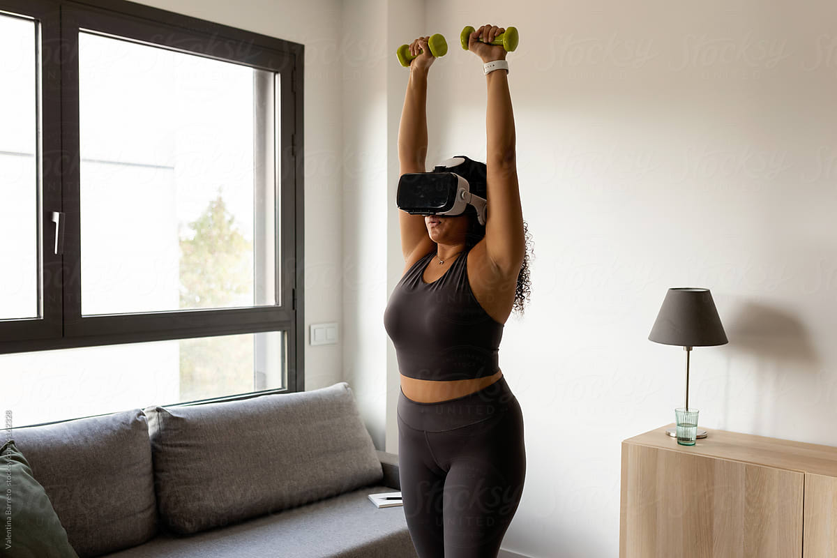 Woman exercising with virtual reality glasses