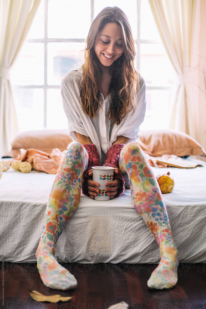 Woman Sitting On Bed And Drinking Delicious Morning Coffee By Stocksy Contributor Jovo 7097