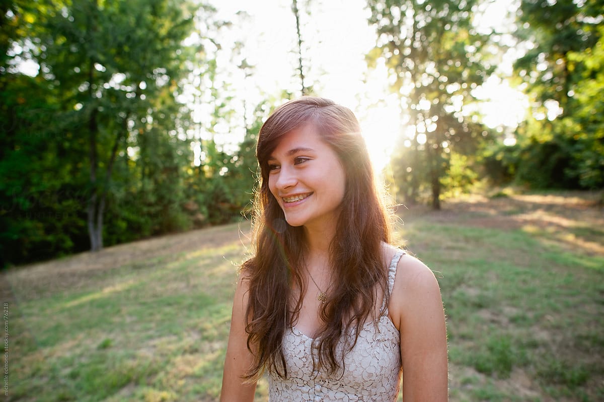 Girl Smiling With Sunset Behind Her By Stocksy Contributor Michelle Edmonds Stocksy 8582