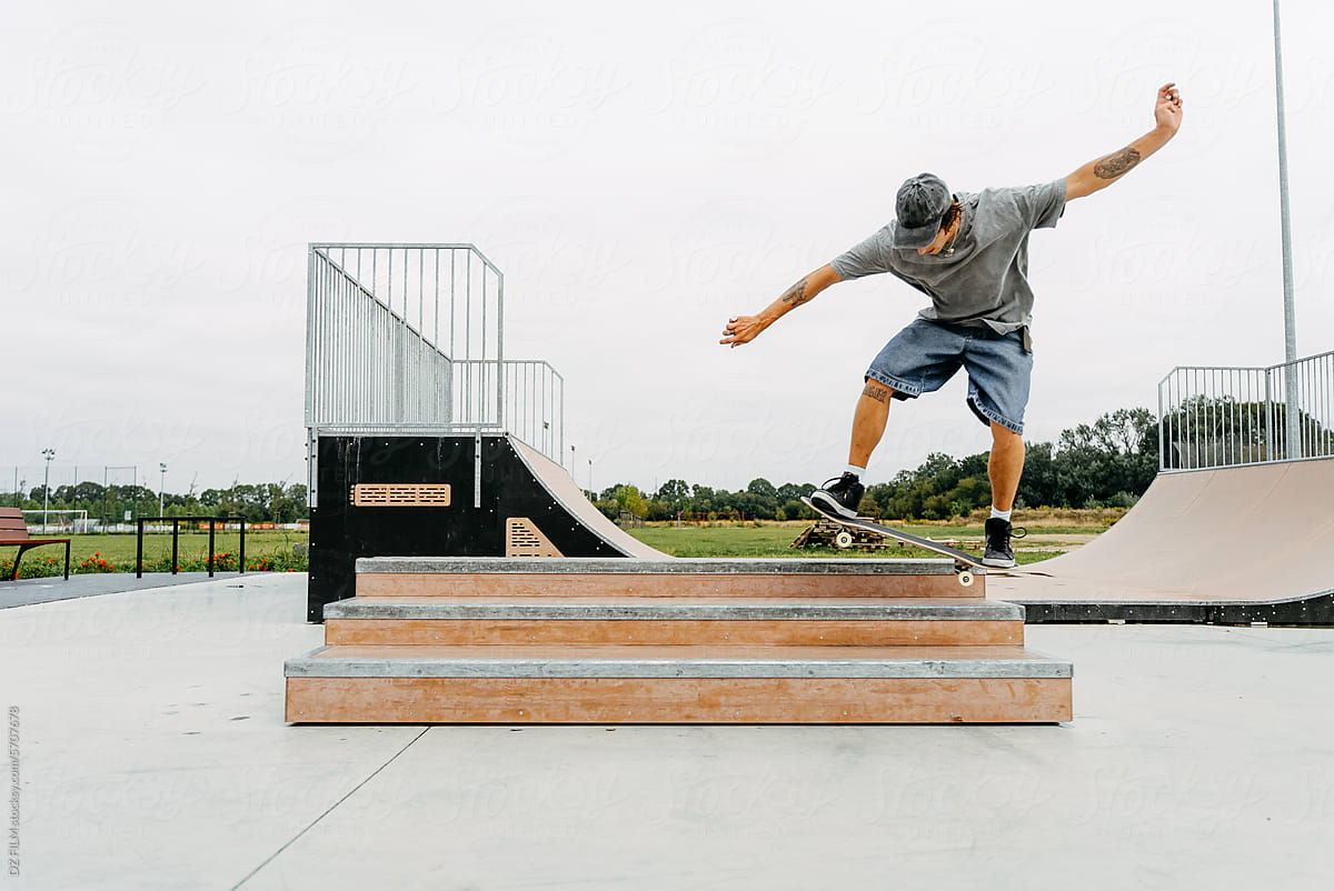 A man rides a skateboard in a skate park