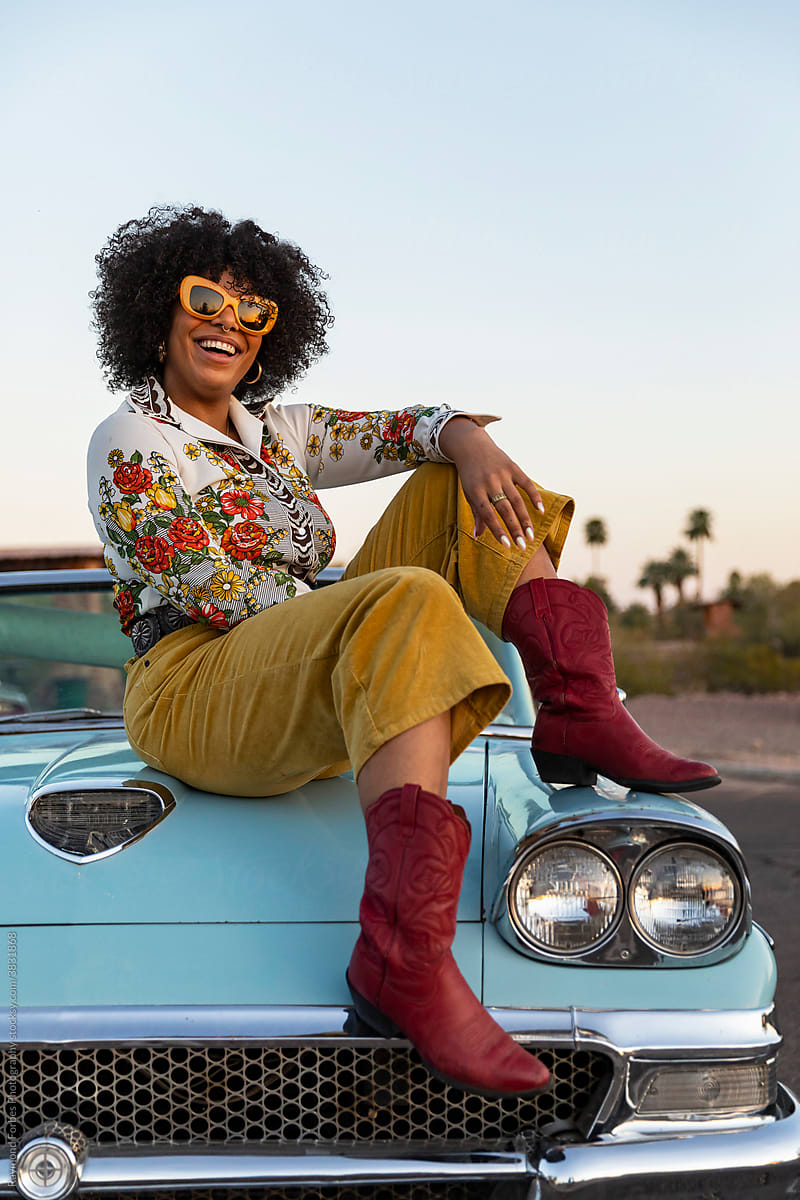 Portrait of Smiling Black Woman next to Vintage American car