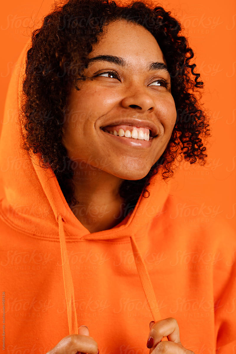 Content latina model woman in orange studio portrait