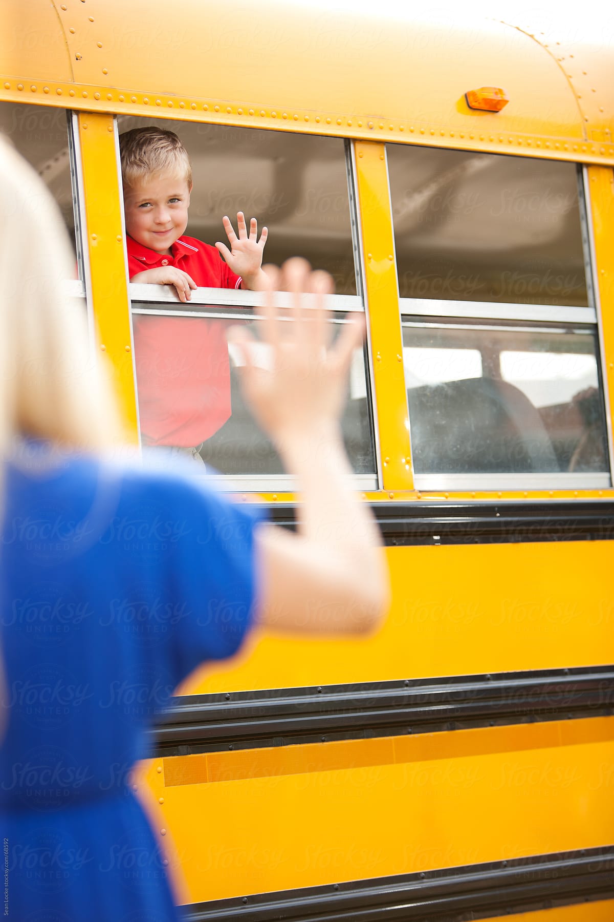 children waving goodbye at school