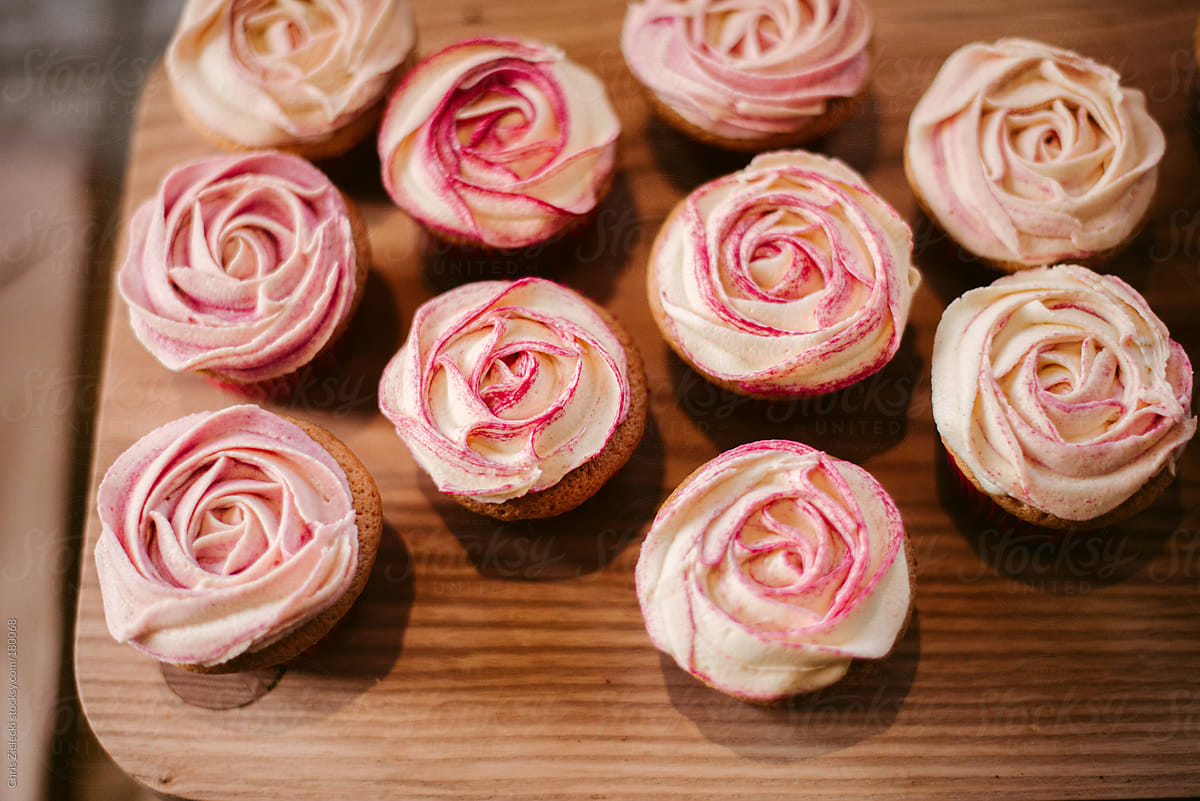 Yummy Muffins With Rose Petal Buttercream On Wooden Surface by Chris ...