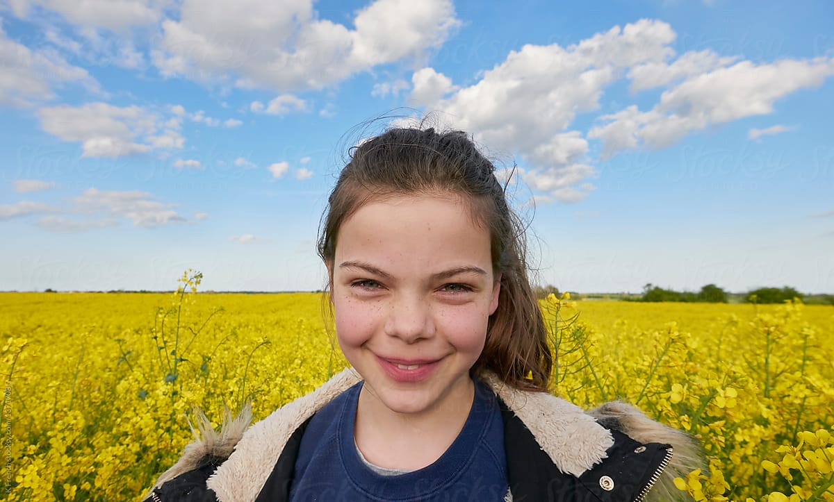 Rapeseed field with smiling girl
