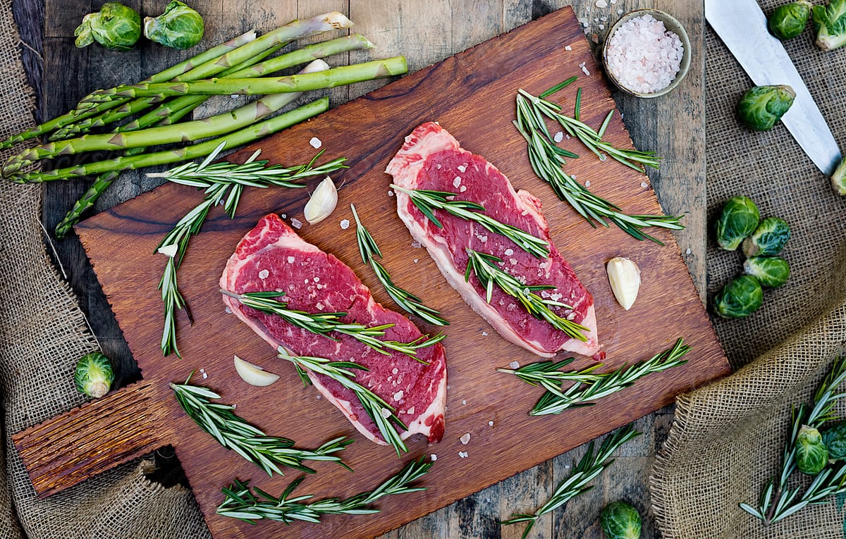 Raw Sirloin Steaks with Rosemary From Above