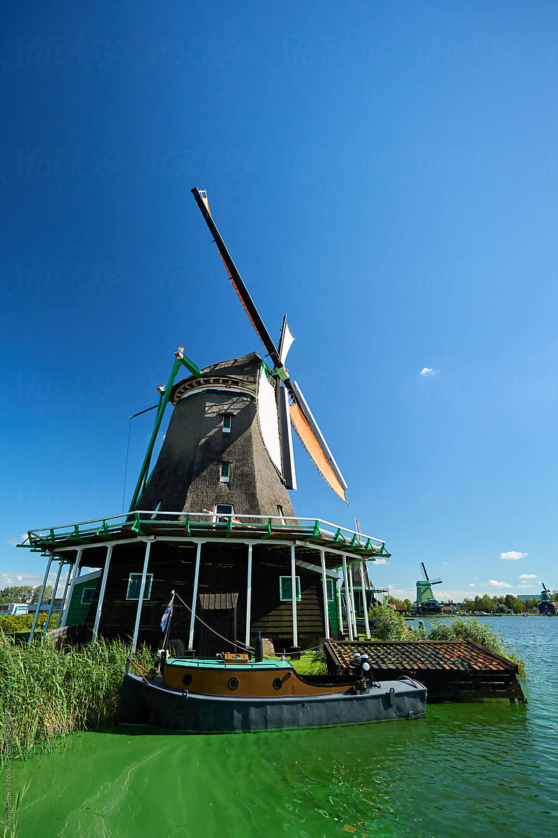 Stereotypical Netherlands windmill and Dutch boat - tourist attraction