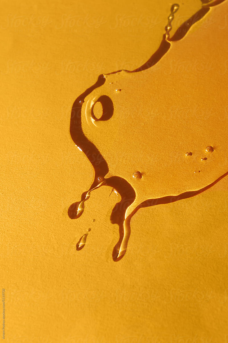 Golden oil spots on a yellow background