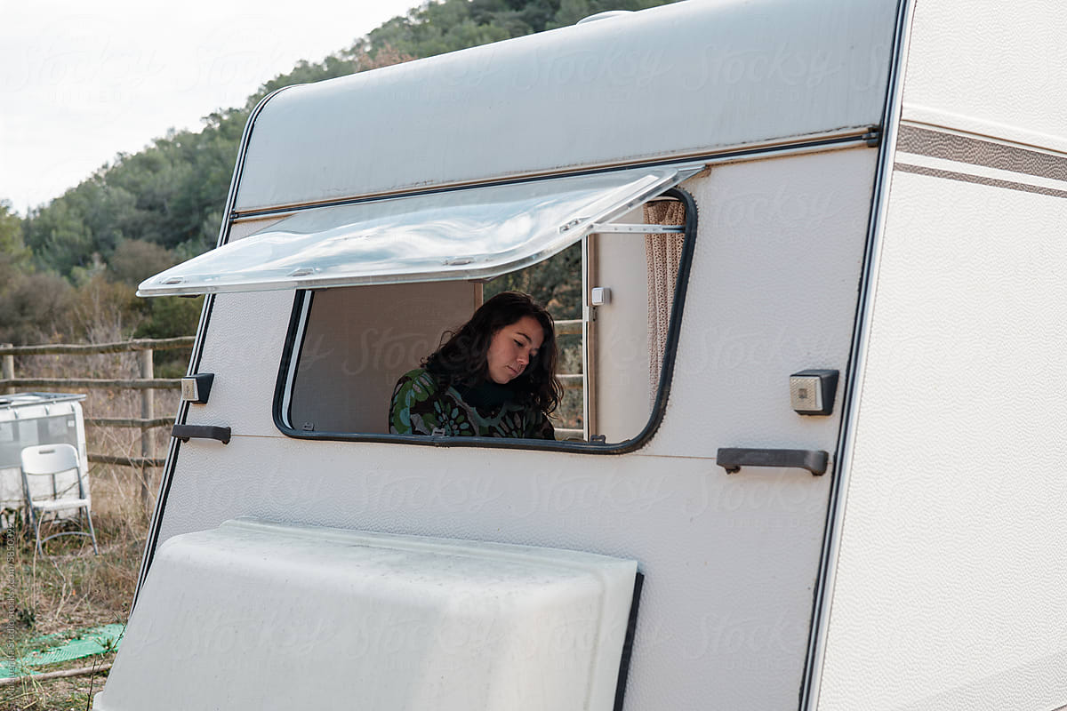 woman inside a caravan while camping