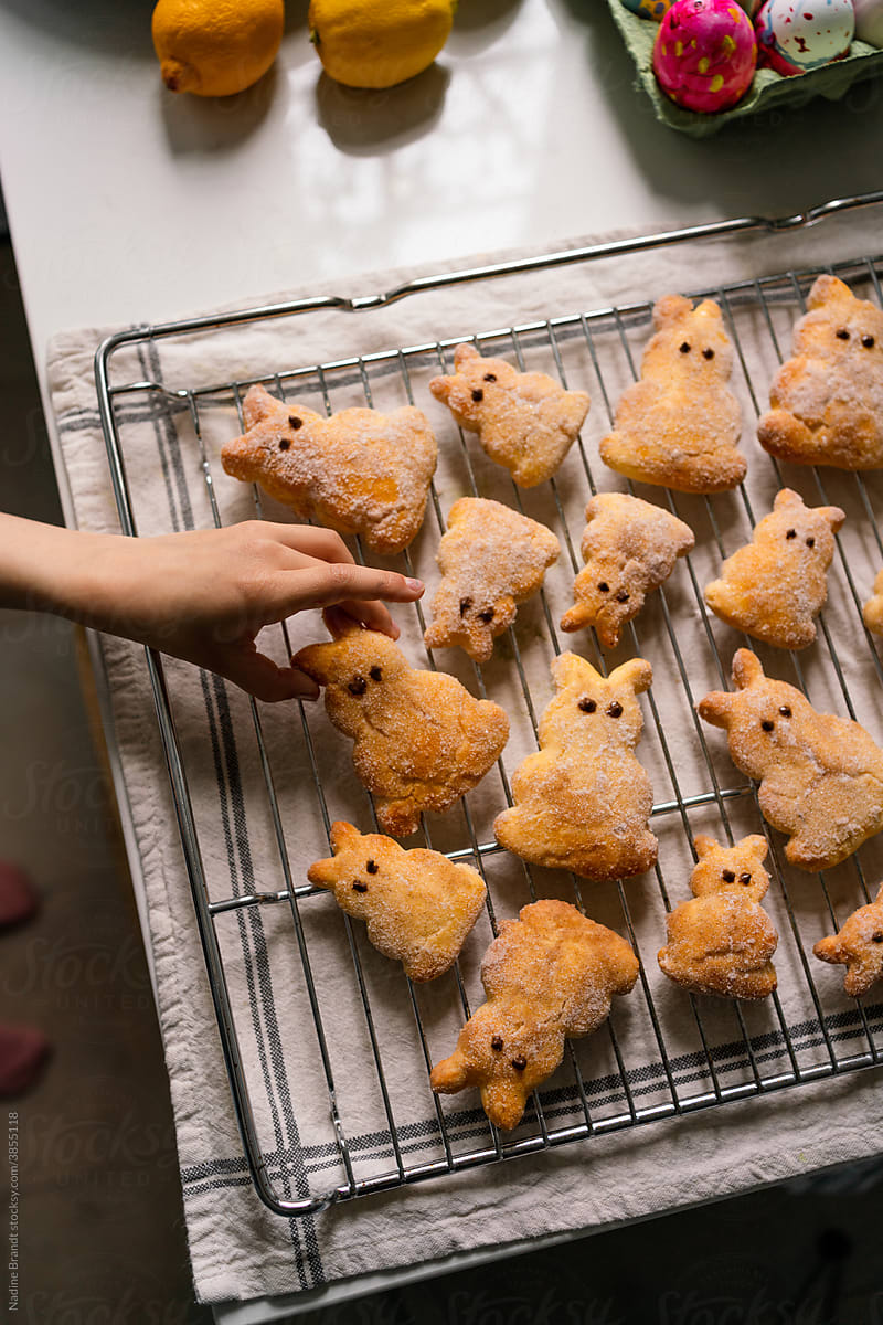 Kids hand reaching for Easter bunny pastries