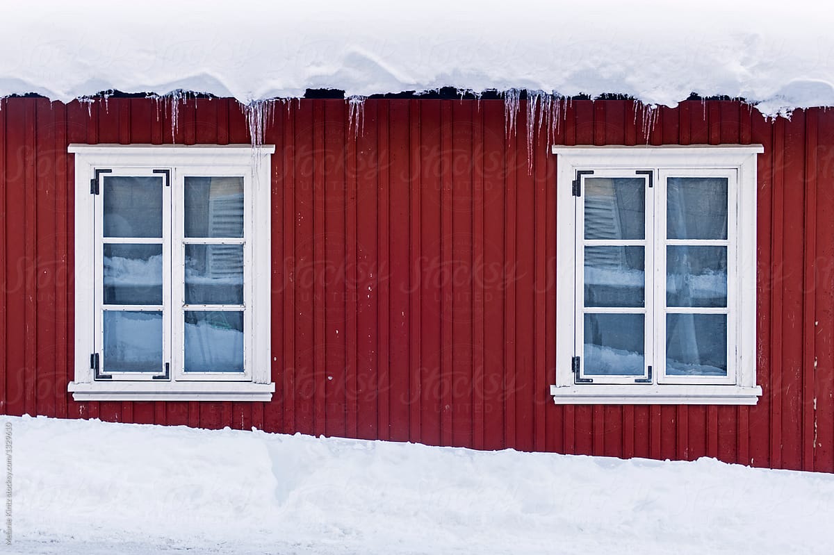 Windows on a red scandinavian house in winter