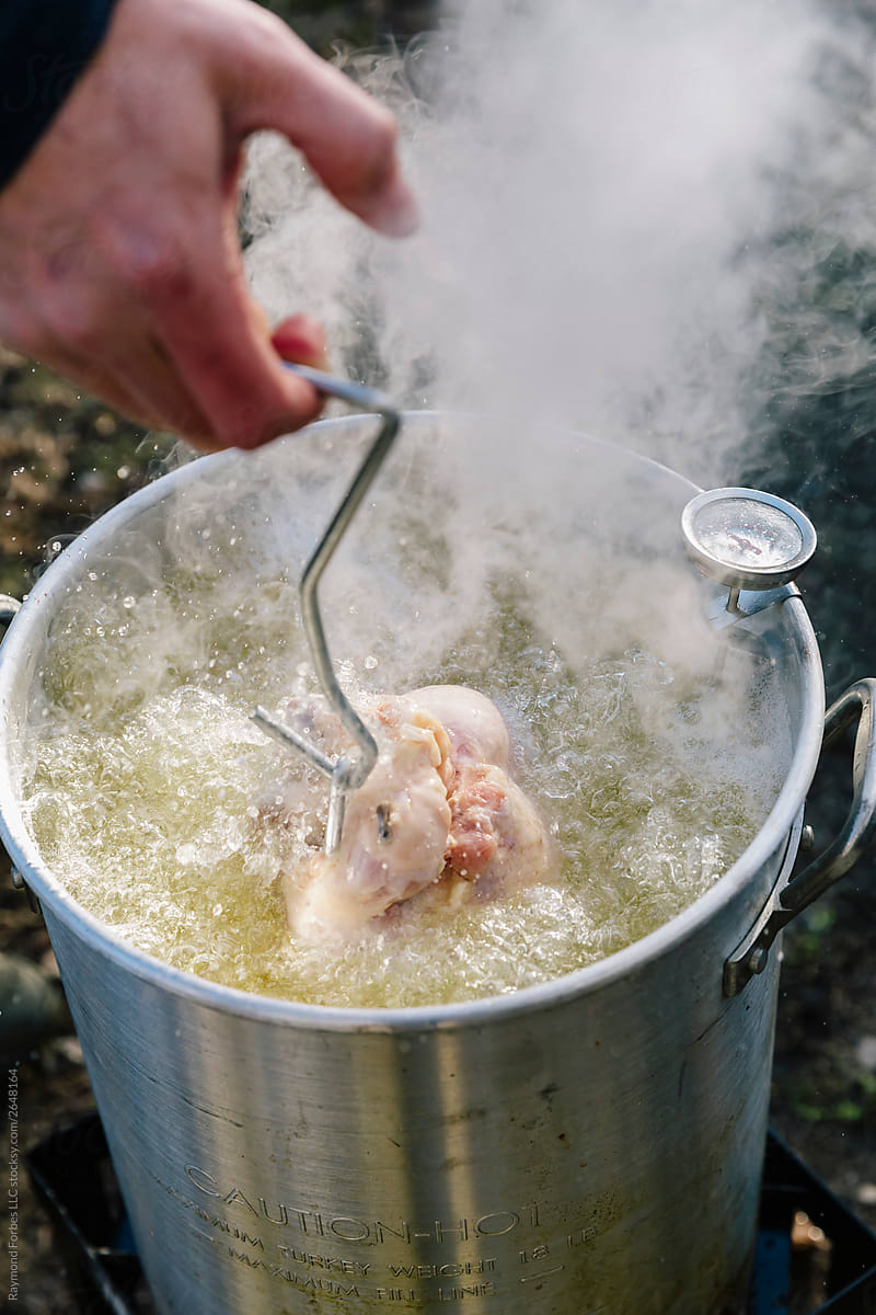 Hot Oil Turkey Fry For Thanksgiving With Temperature Gauge by Stocksy  Contributor Raymond Forbes LLC - Stocksy
