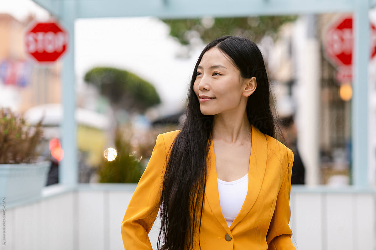 Positive female manager in trendy suit on street